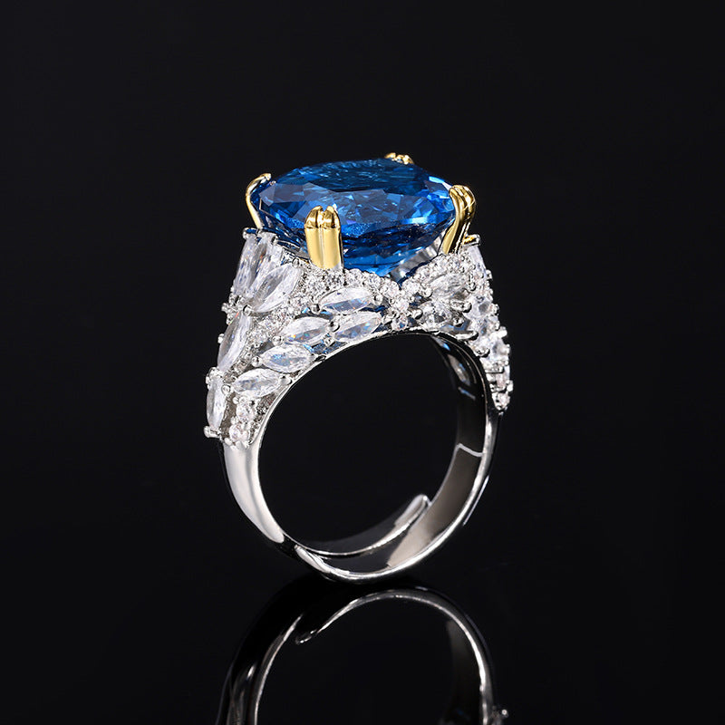 A silver plating blue cocktail brass ring, inlaid with a blue center stone and white marquise-cut zirconias.