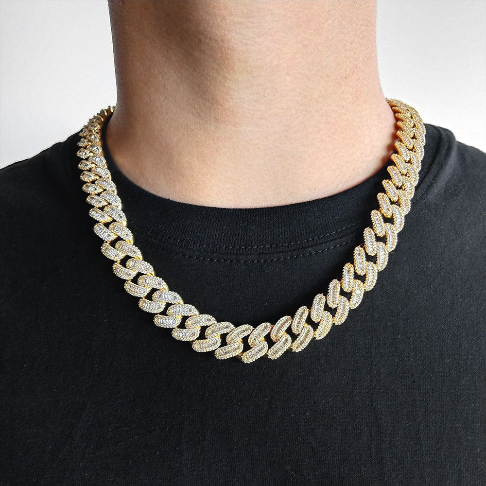 The model showcases the chunky iced out cuban link necklace.
