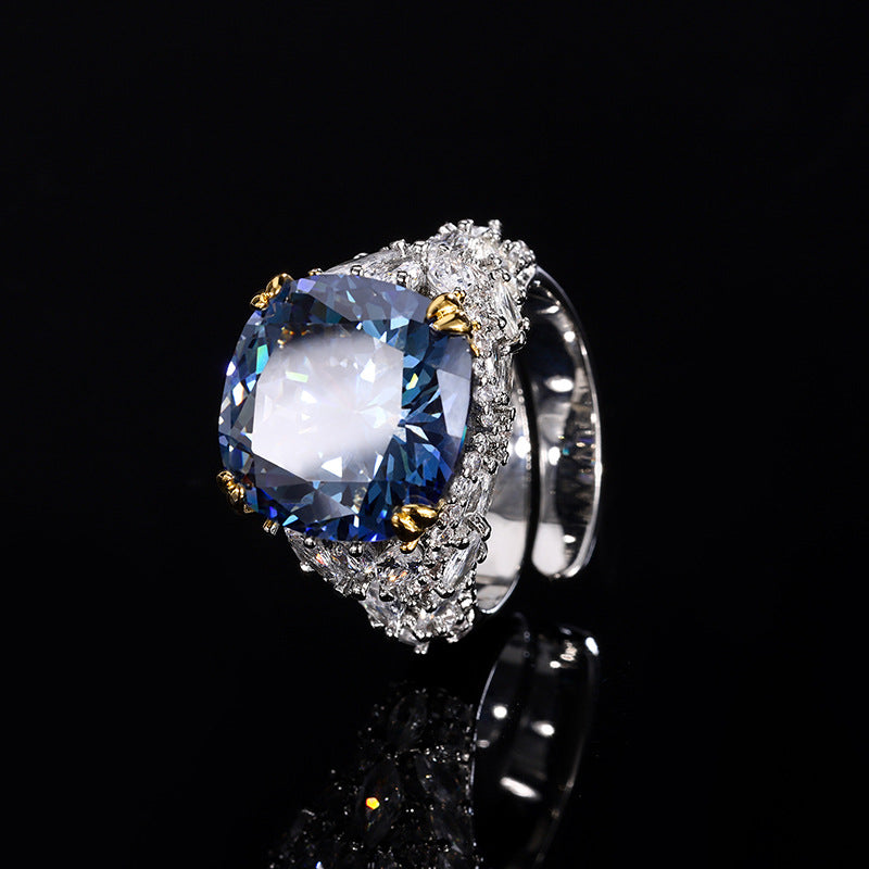 A silver plating beige cocktail brass ring, inlaid with a dark blue center stone and white marquise-cut zirconias.