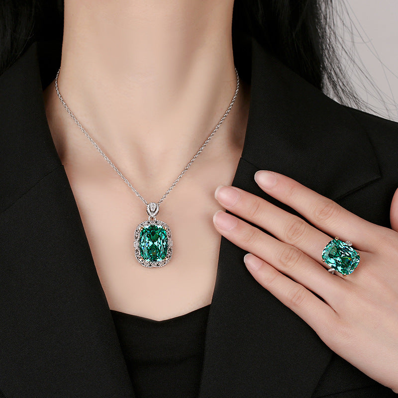 The model showcases the emerald zirconia jewelry set.