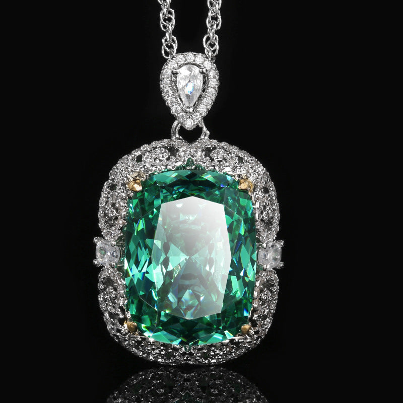 The halo necklace of the emerald zirconia jewelry set, inlaid with a large emerald-cut green center stone, with the twist chan. Brass with silver-gold plating.