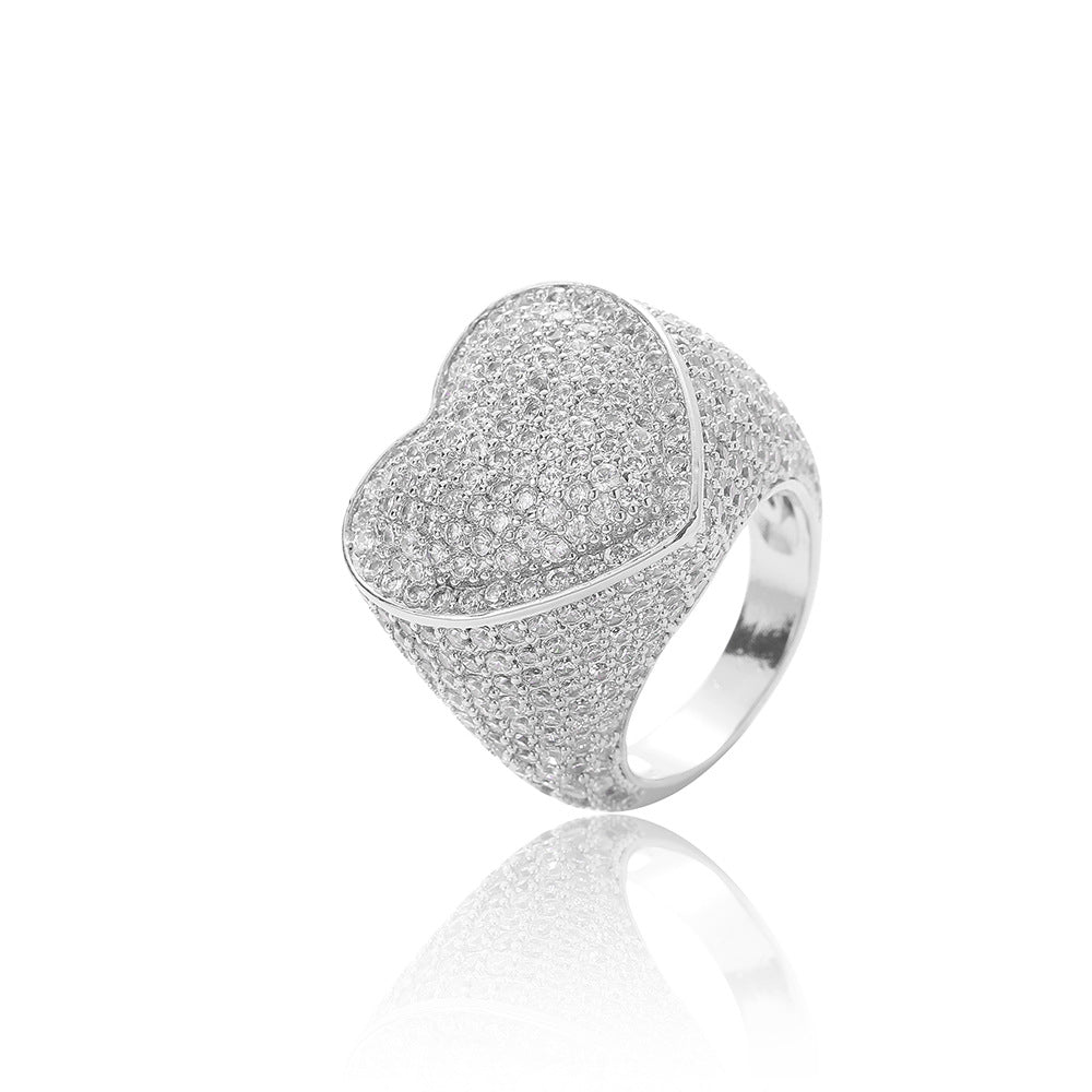 Iced out heart ring pave white round brilliant cubic zirconias. Brass with silver plating.