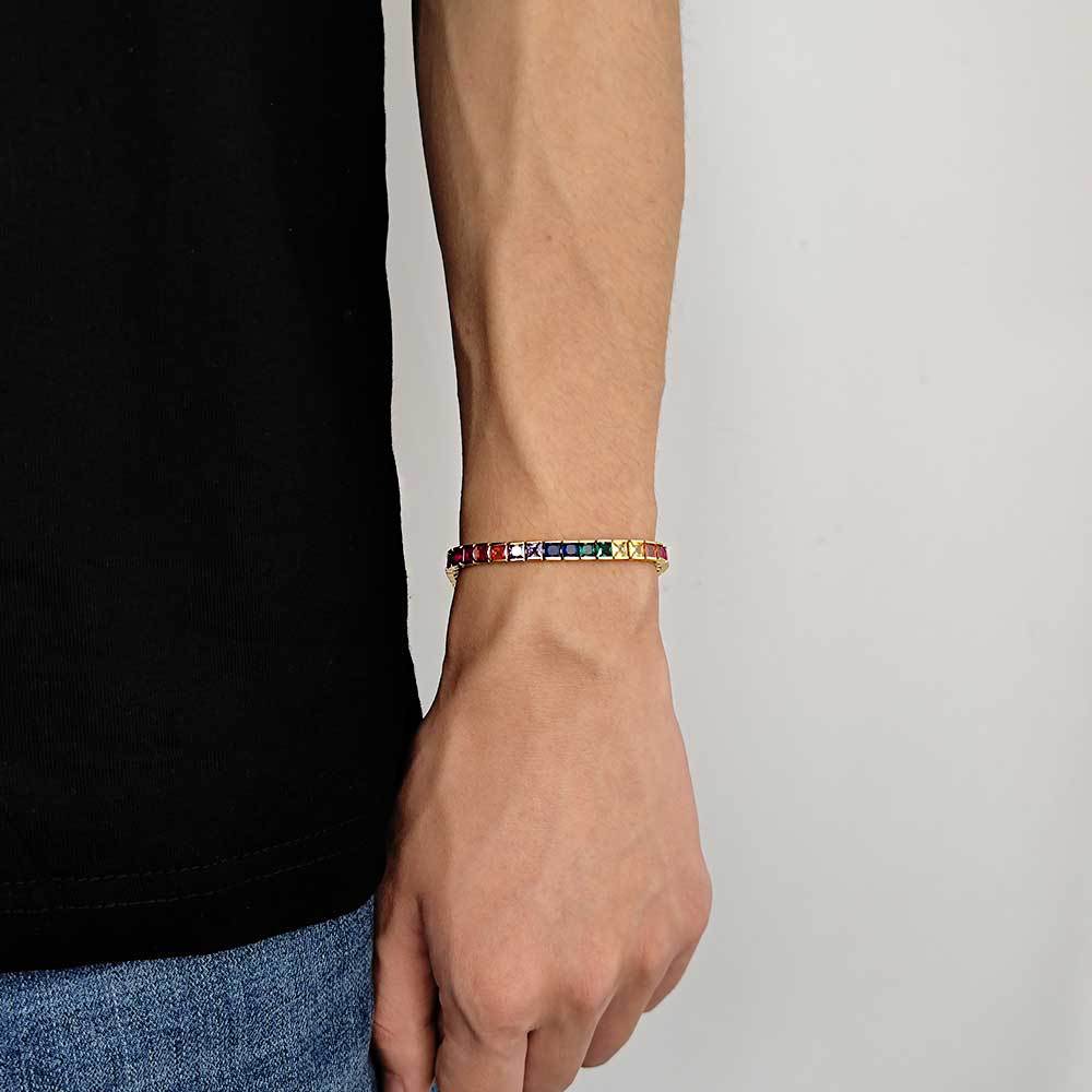 The model showcases the rainbow square gemstone with gold plating.