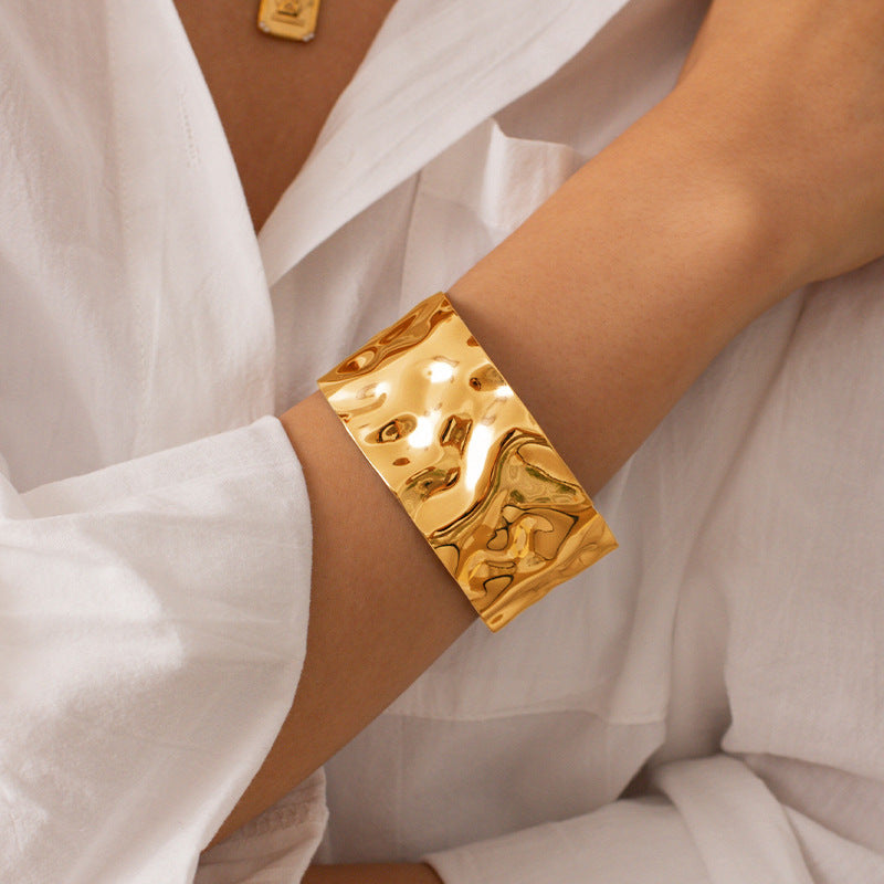 A gold plating water texture design stainless steel bangle bracelet