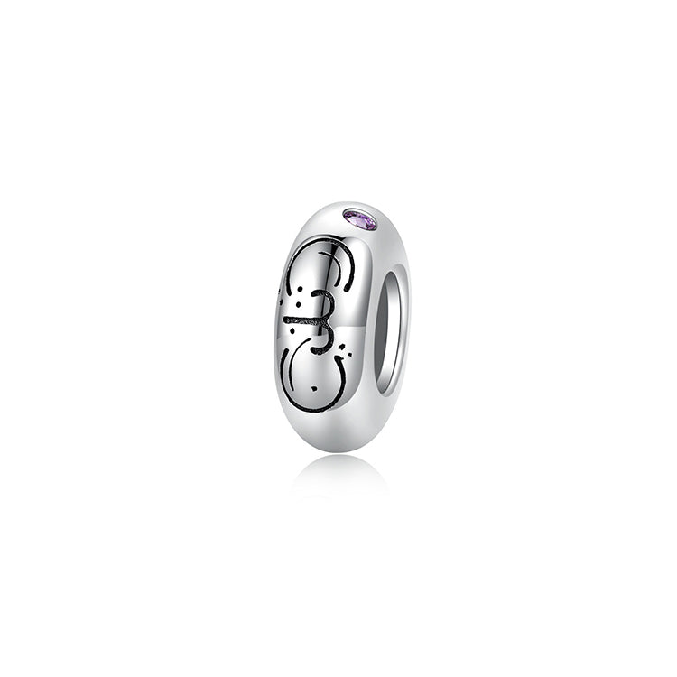 A sterling silver spacer bead, design in Aries pattern and light purple birthstone.
