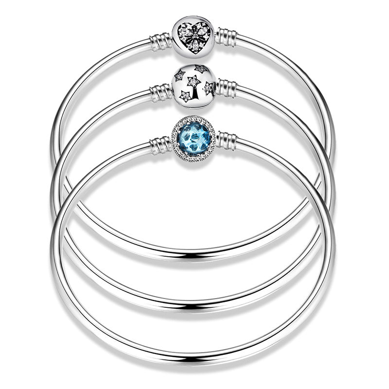 Sterling silver bangle bracelets. Design in heart, rose, stars, snow flake. with zirconias and blue glass.