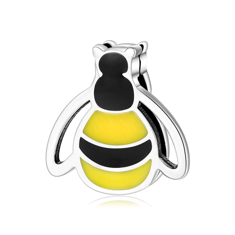 A sterling silver yellow enamel bee charm