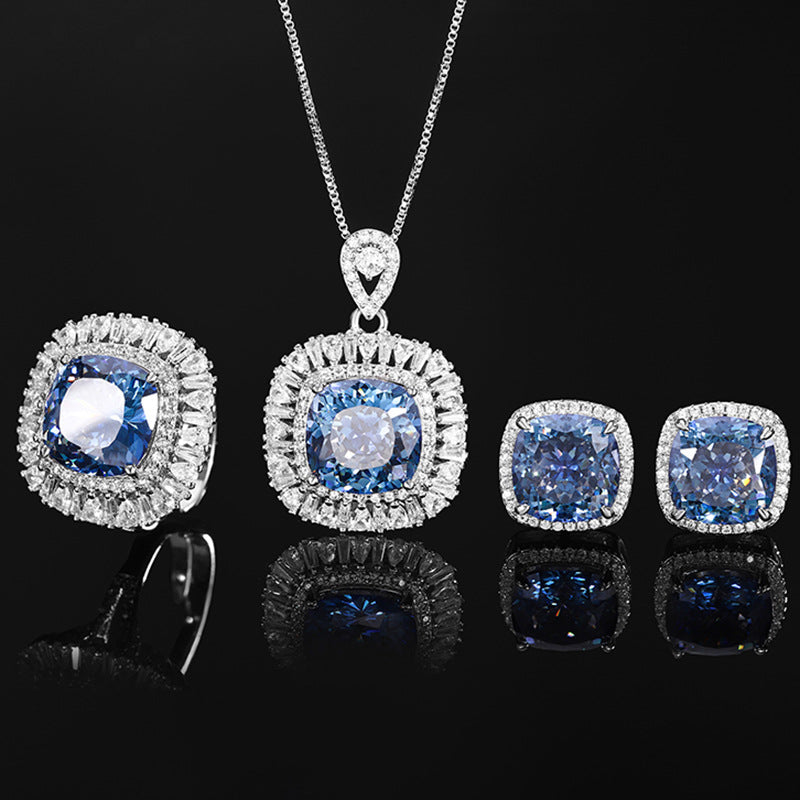 The blue sapphire zirconia jewelry set, halo design with a blue center stone and white zirconias. Brass with silver plating.