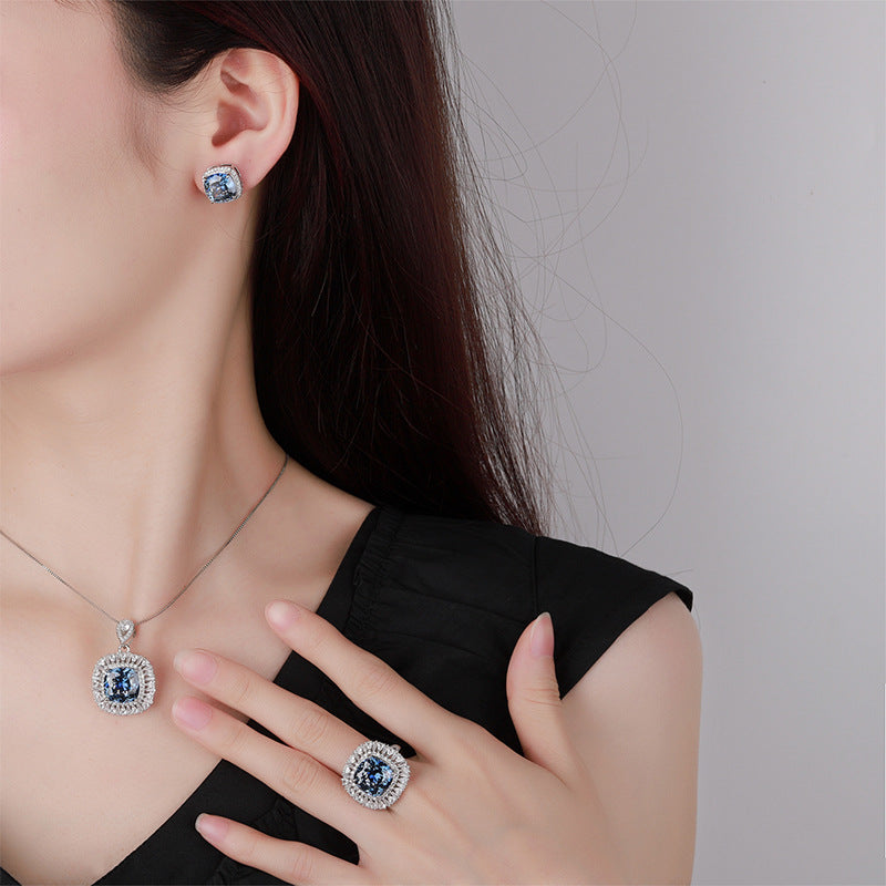 The model showcases the blue sapphire zirconia jewelry set.