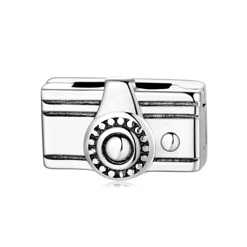A sterling silver camera design charm