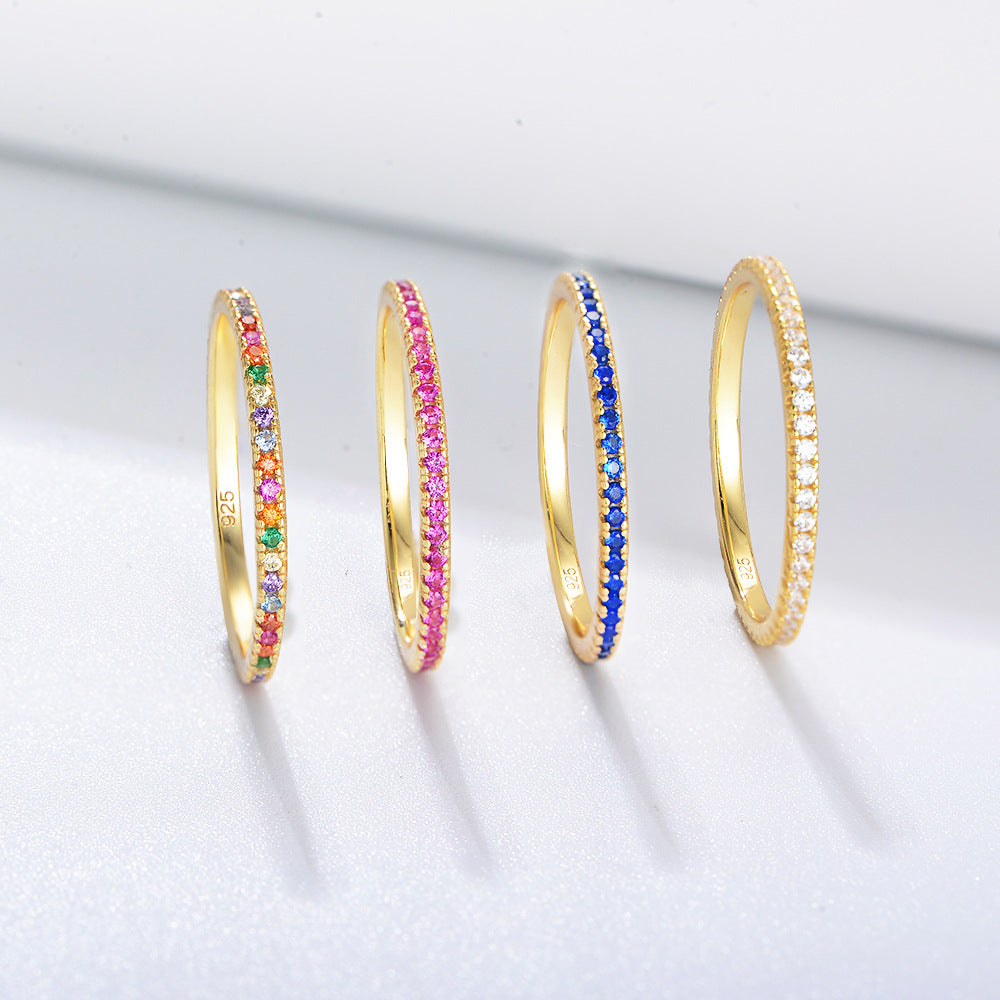 A sterling silver eternity ring band, inlaid with blue, white, pink, colorful zirconias. Plating with gold.