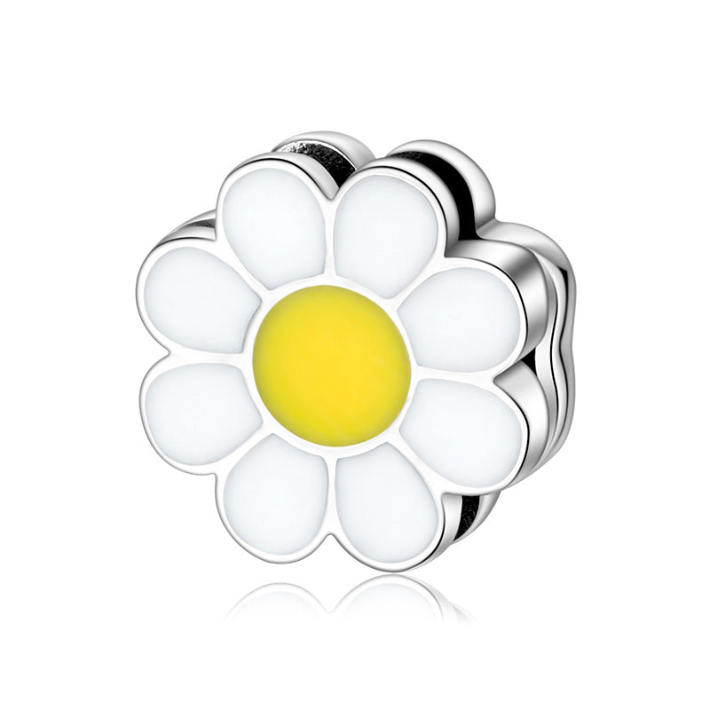 A sterling silver enamel daisy charm