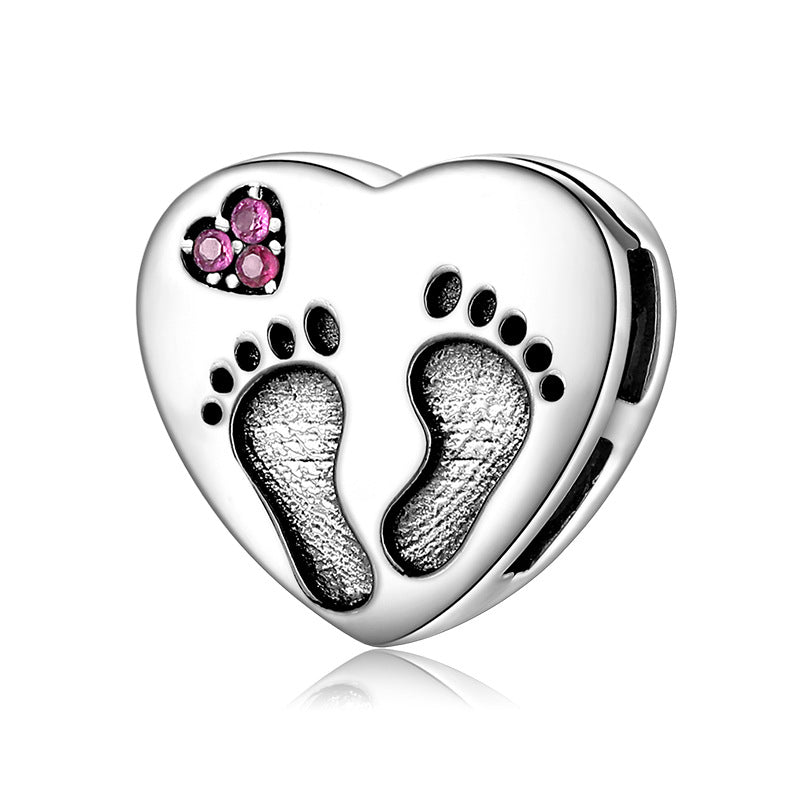 A sterling silver footprint design with zirconias charm