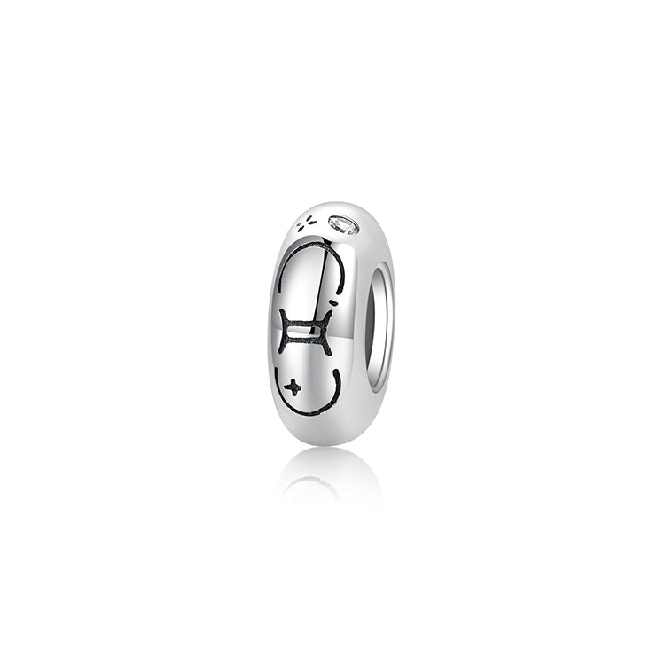 A sterling silver spacer bead, design in Gemini pattern and white birthstone.