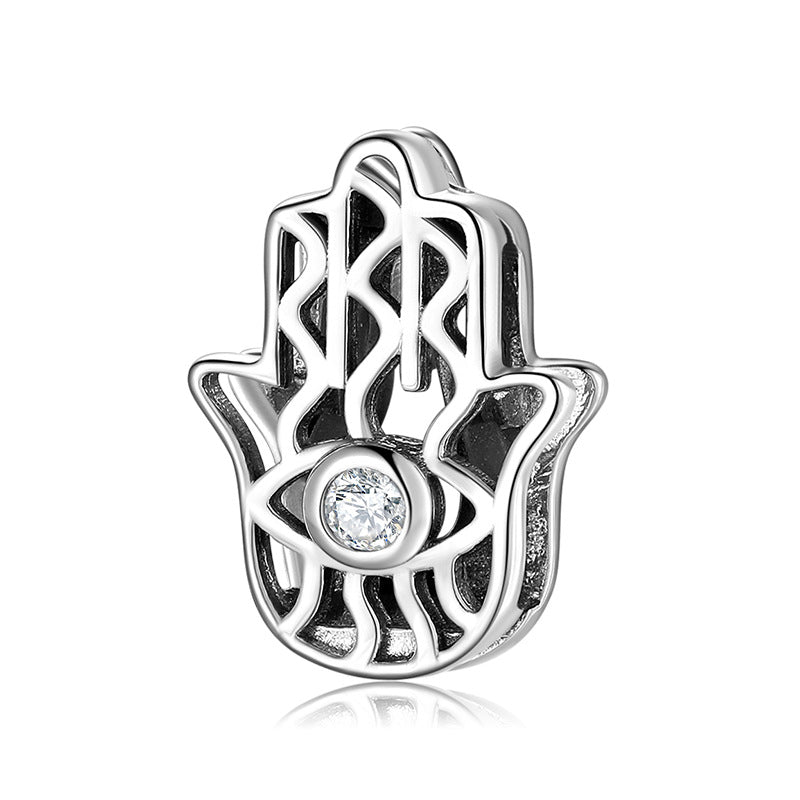 A sterling silver hamsa hand design with a white zirconia charm