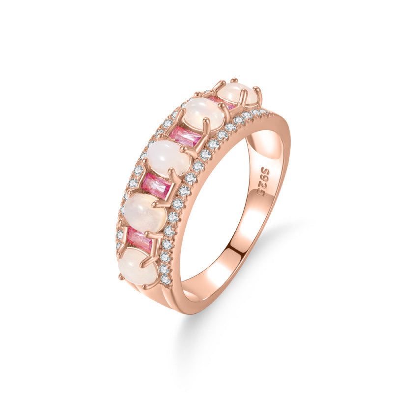 A sterling silver gemstone ring, inlaid with natural white opal and pink zirconias. Plating with rose gold.