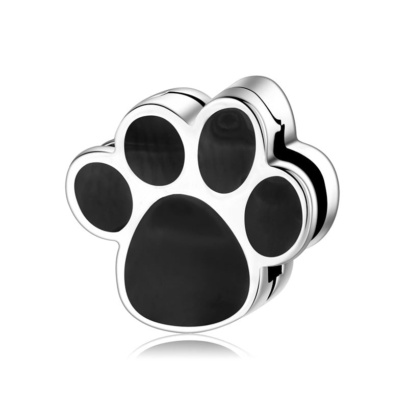 A sterling silver black enamel palm charm