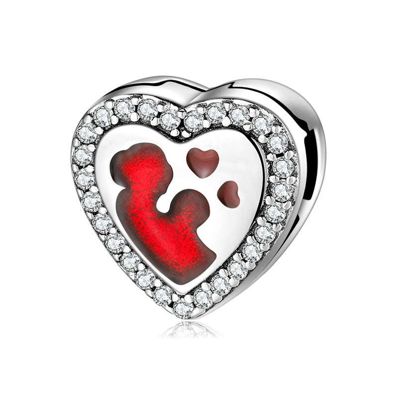 A sterling silver red enamel parent-child with zirconias paved charm