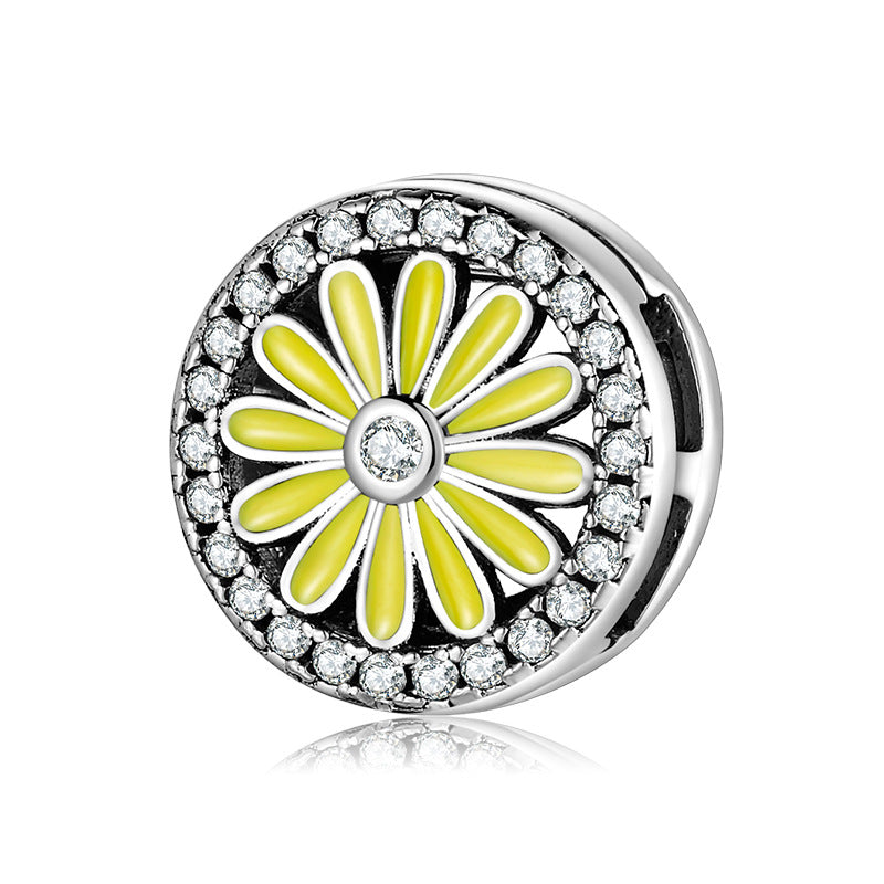 A sterling silver zirconias paved daisy with yellow enamel charm