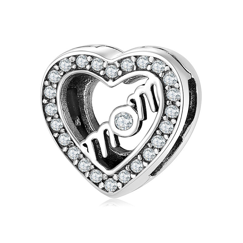 A sterling silver written mom with zirconias paved heart charm