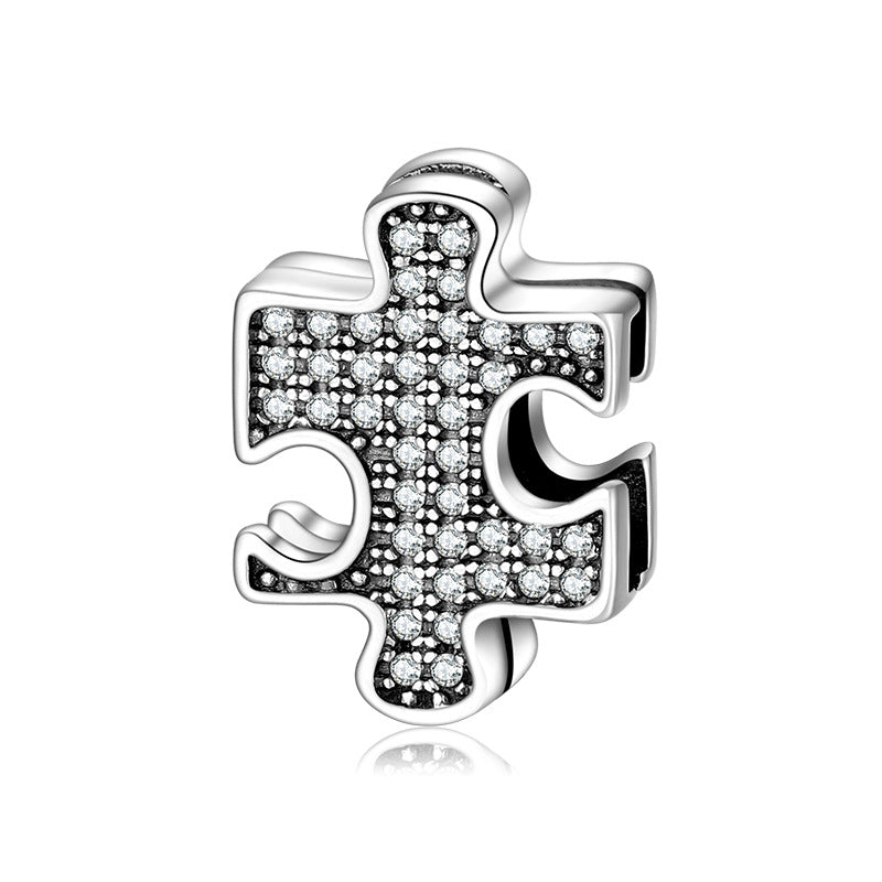 A sterling silver zirconias paved puzzle charm