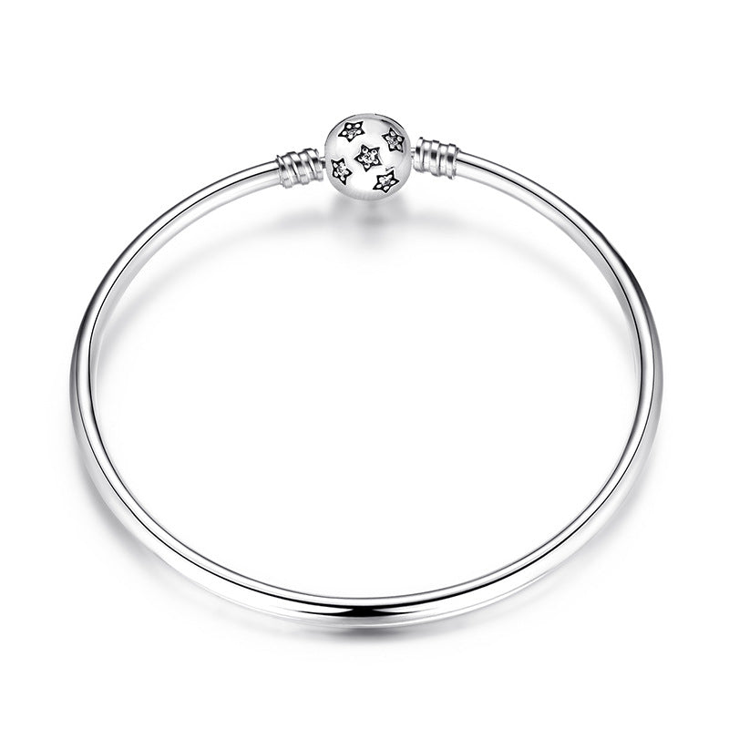 A sterling silver bangle bracelet, the box clasp design in stars with many zirconias.