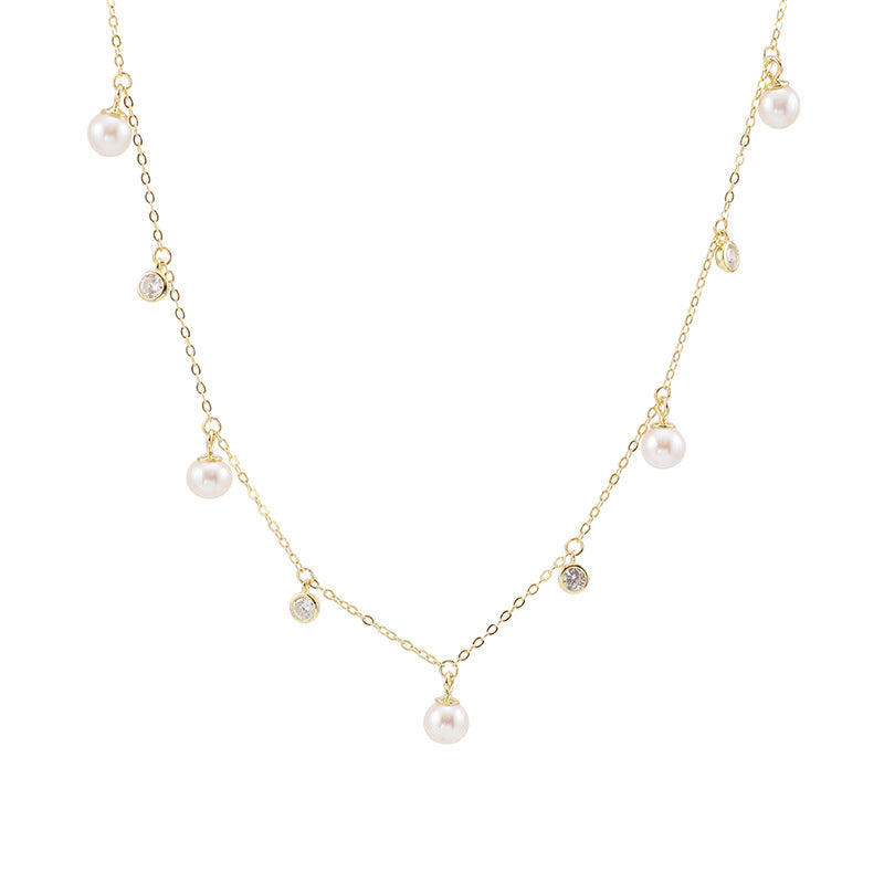A gold plating silver pearl choker. Cable chain with many hanging white zirconia and pearl.