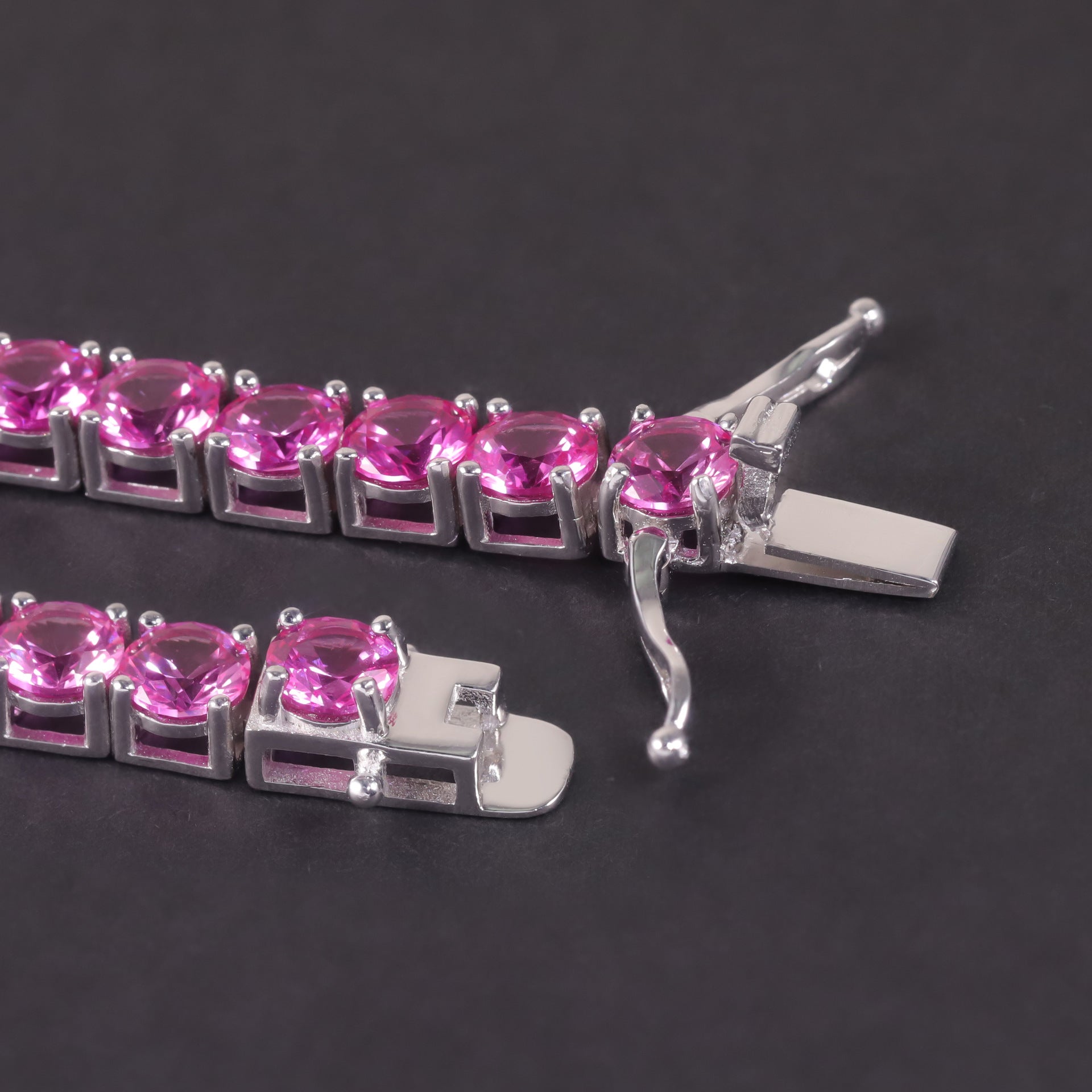 Close-up of the pink synthetic sapphire tennis bracelet clasp, hook clasp.