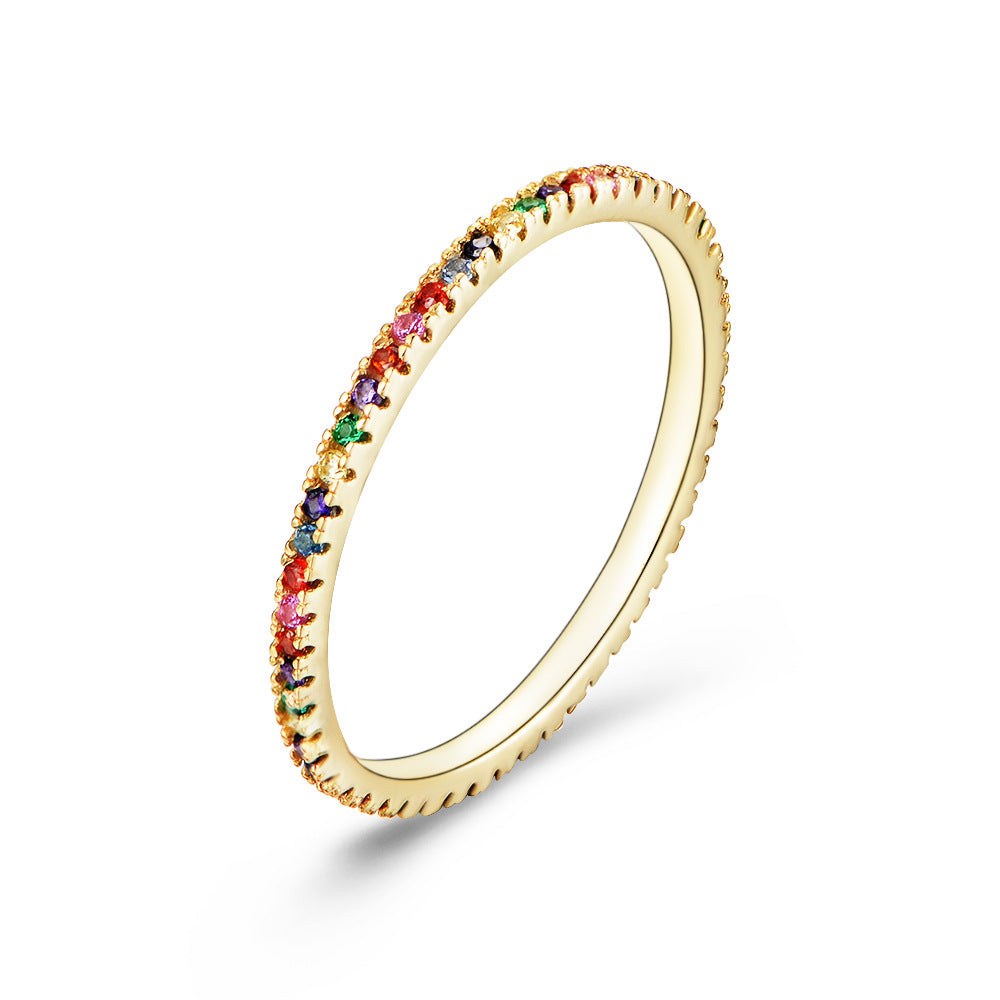 A sterling silver eternity ring band, inlaid with colorful zirconias. Plating with gold.