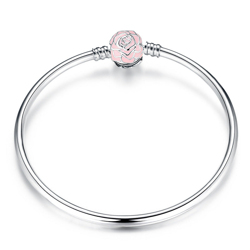 A sterling silver bangle bracelet, the box clasp design in rose with pink eanmel.