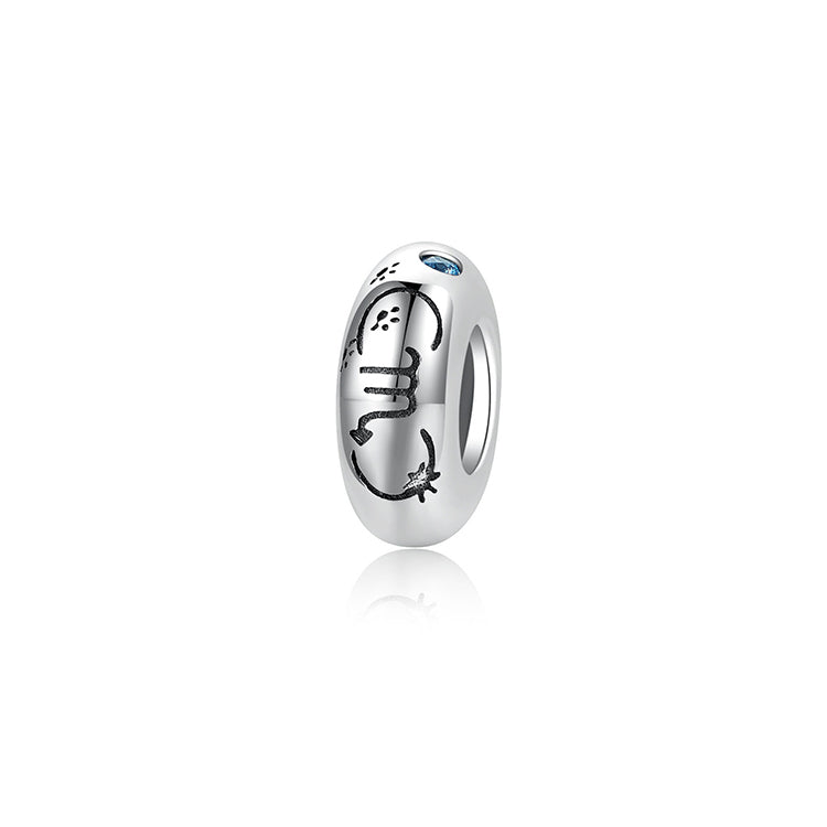 A sterling silver spacer bead, design in Scorpio pattern and blue birthstone.
