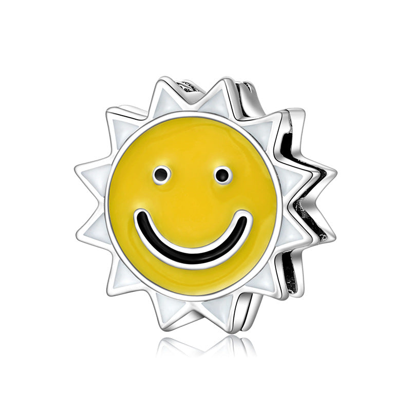 A sterling silver enamel smiling sun charm