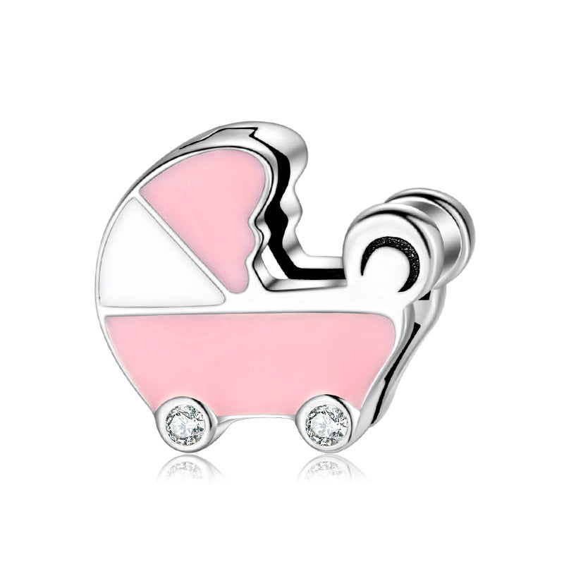 A sterling silver enamel stroller charm