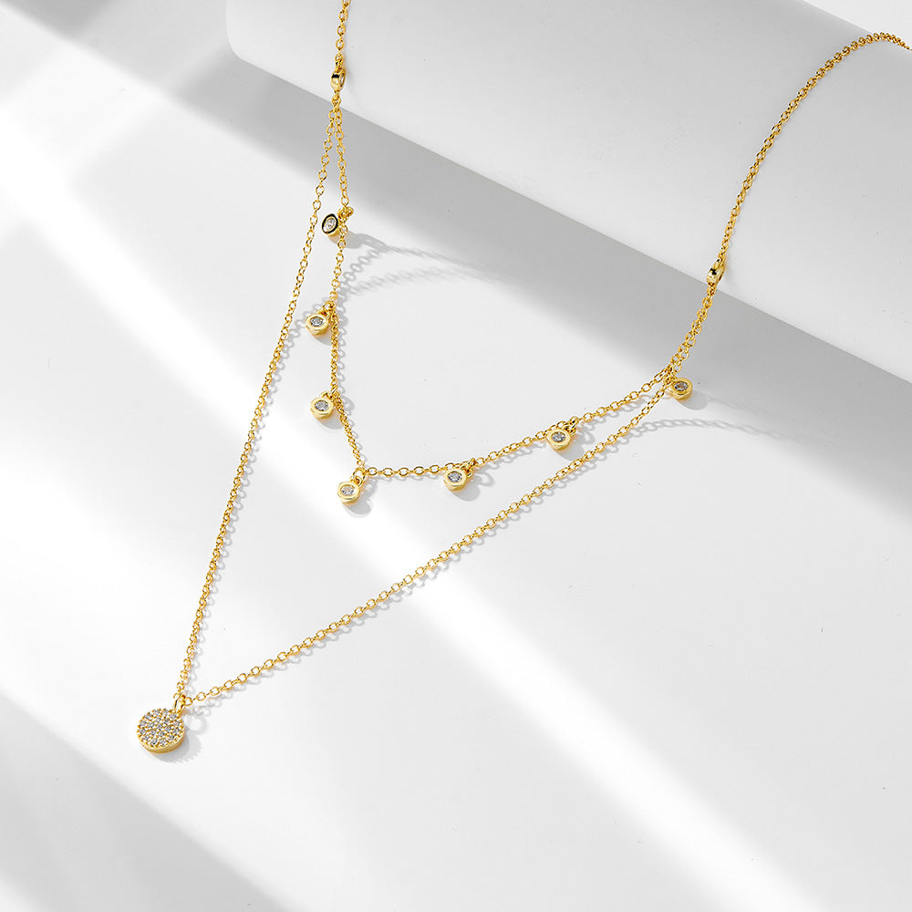 A sterling silver layered necklace with many white zirconias, gold plated.