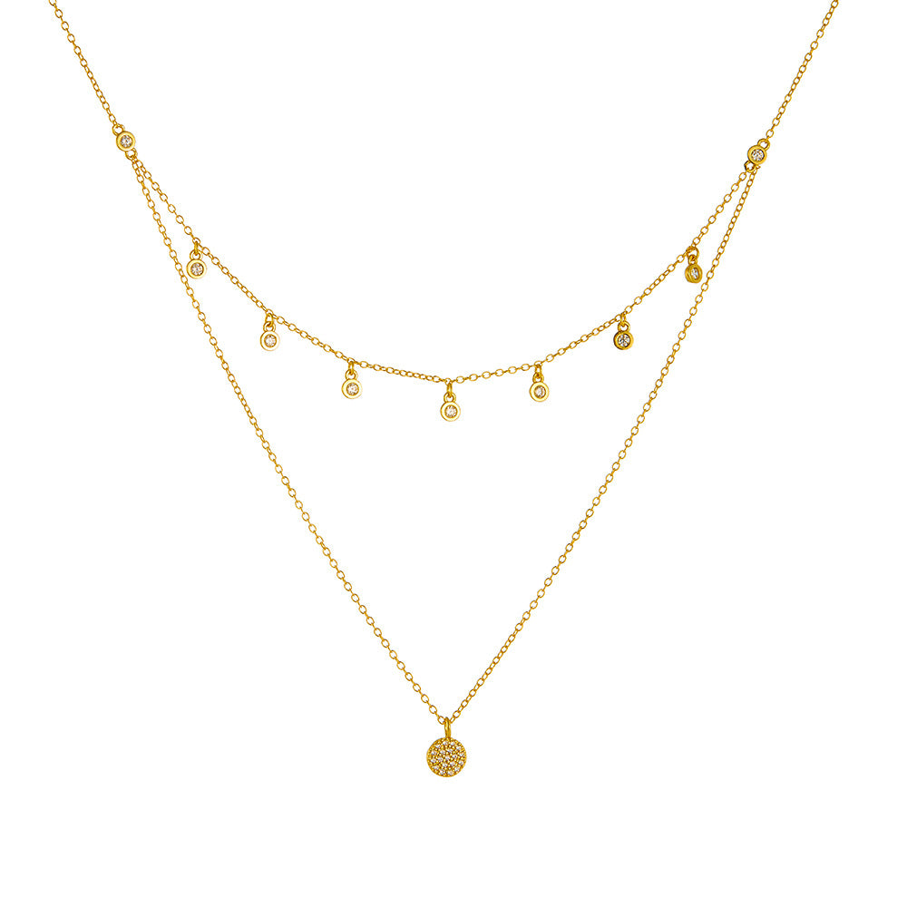 A sterling silver layered necklace with many white zirconias, gold plated.