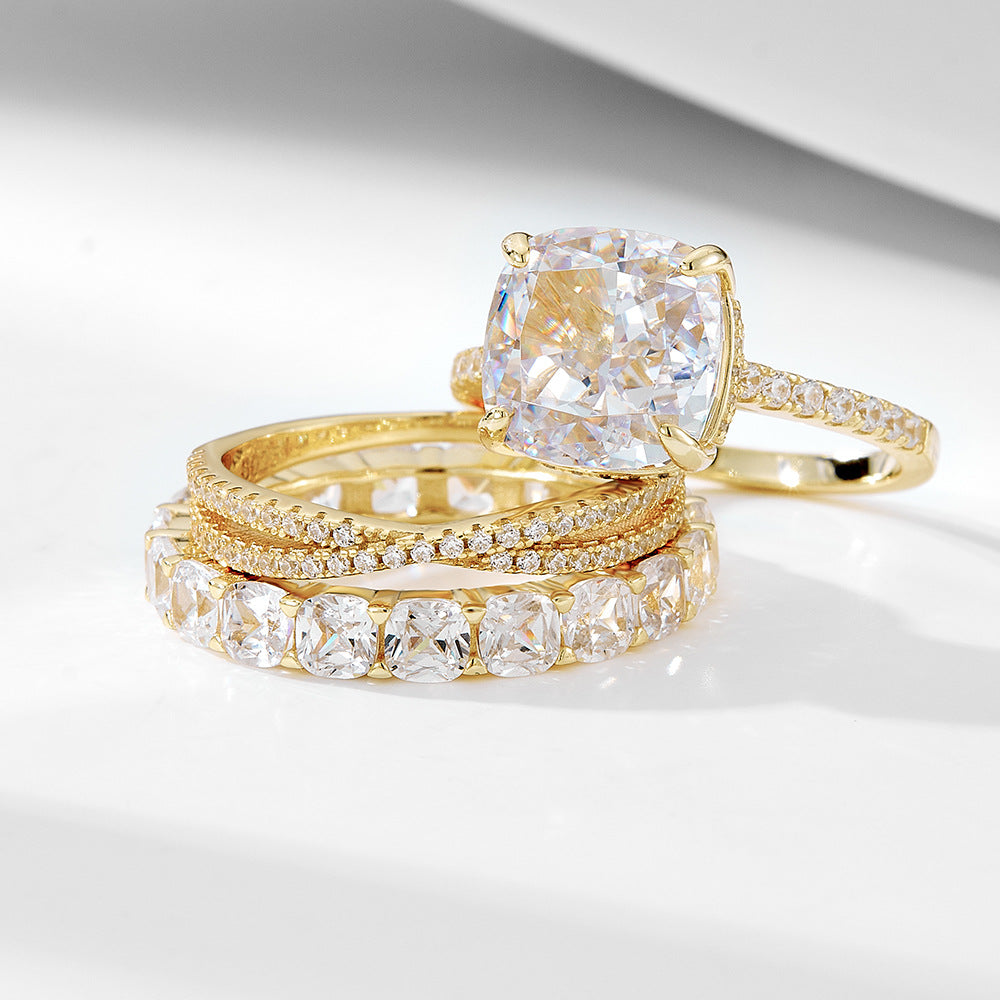 A sterling silver zirconia ring set, including one primary ring and two secondary rings, plating with gold.