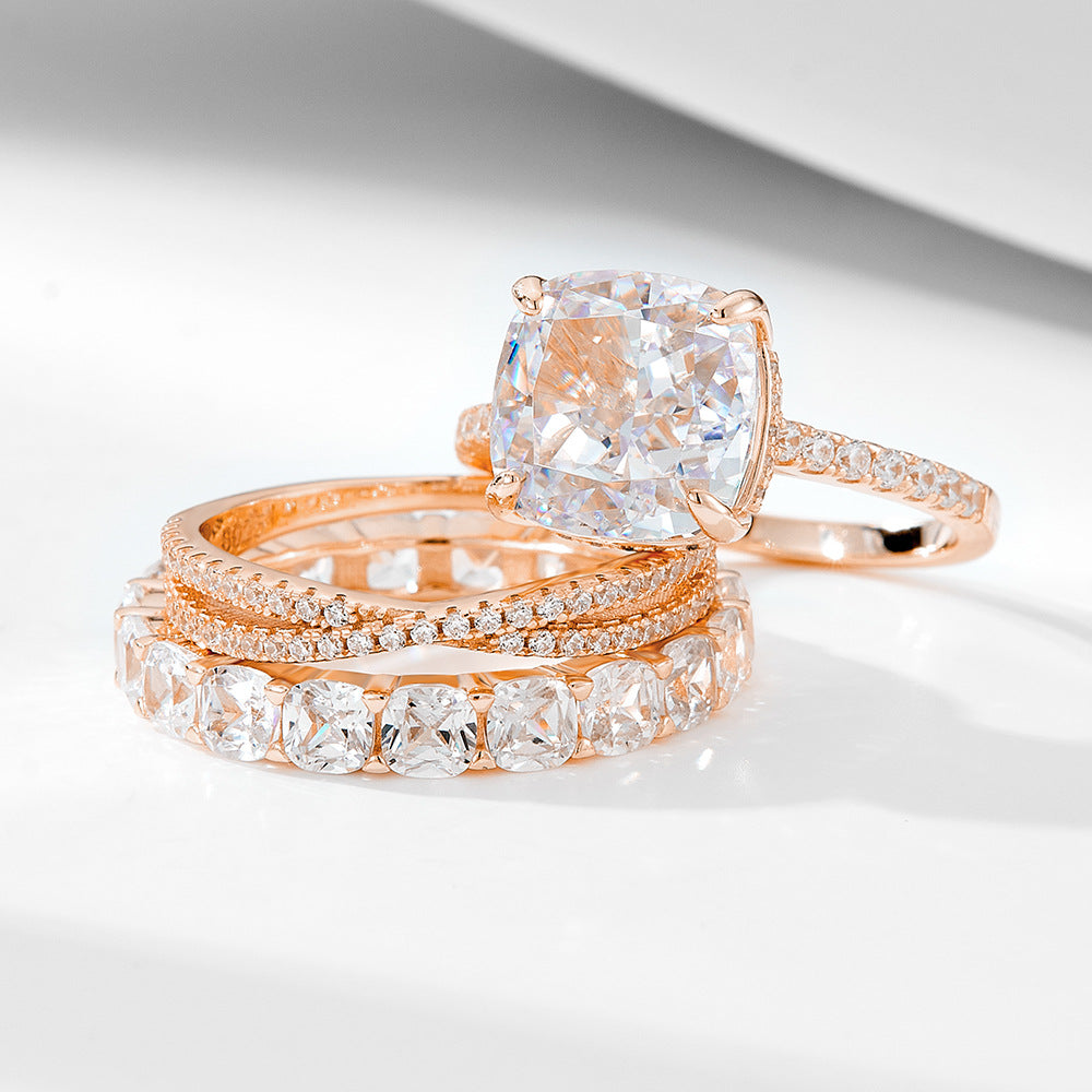 A sterling silver zirconia ring set, including one primary ring and two secondary rings, plating with rose gold.