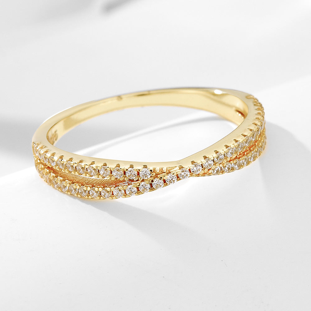 A sterling silver white zirconia cross-designed band, secondary ring of the ring set. Plating with gold.