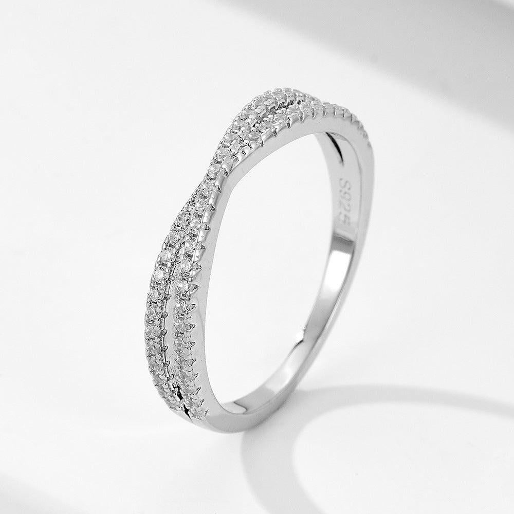 A sterling silver white zirconia cross-designed band, secondary ring of the ring set. Plating with silver.