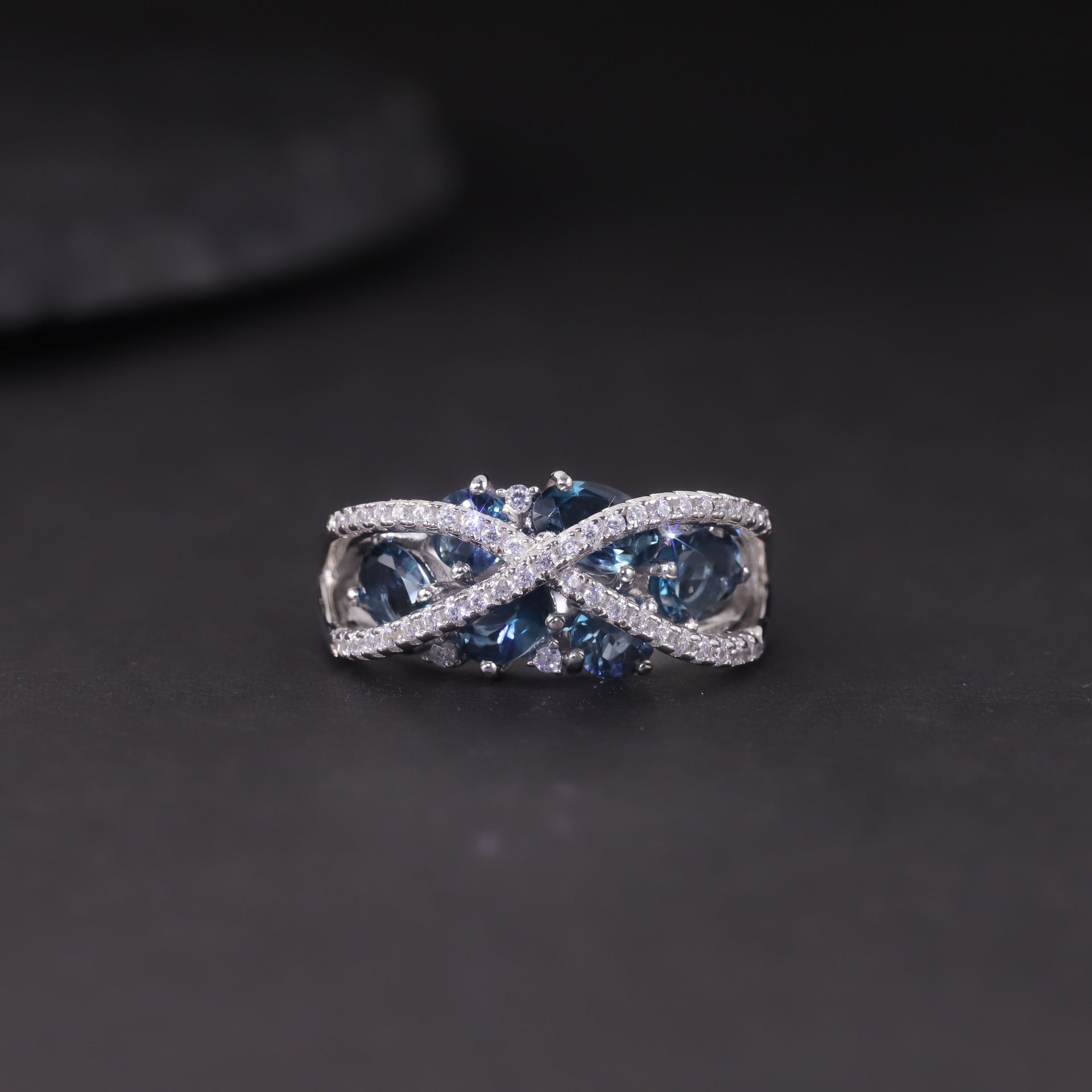 A sterling silver topaz ring, six natral topaz are inlaid in middle, a pave cross design above the stone. Plating with Rhodium.