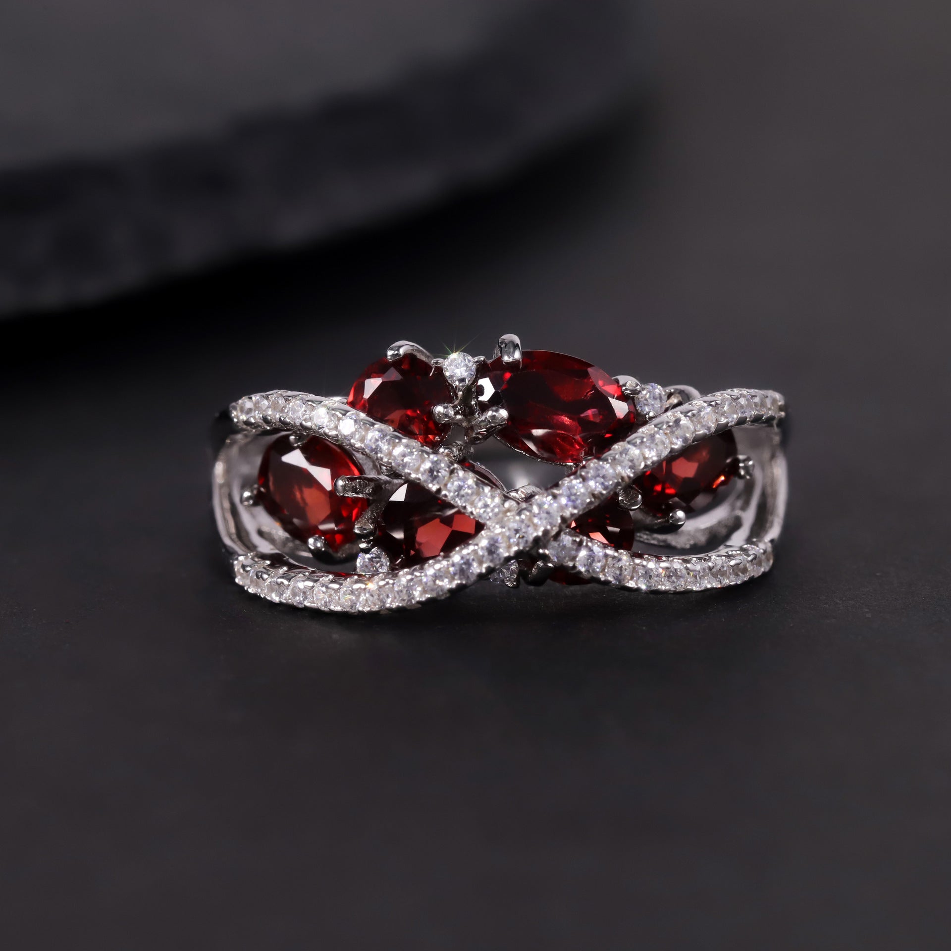 A sterling silver garnet ring, six natral garnets are inlaid in middle, a pave cross design above the stone. Plating with Rhodium.