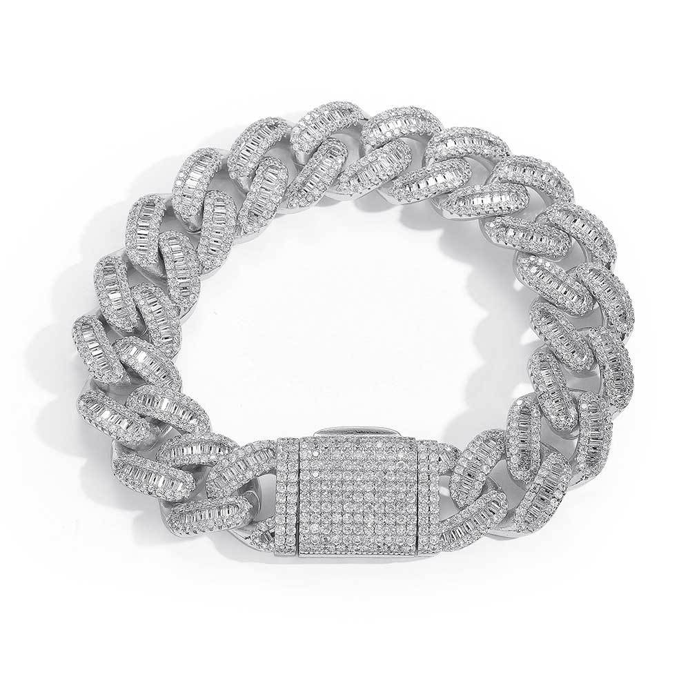 A chunky iced out cuban link bracelet. White baguetee zirconias, iced out box clasp. Brass with silver plating.
