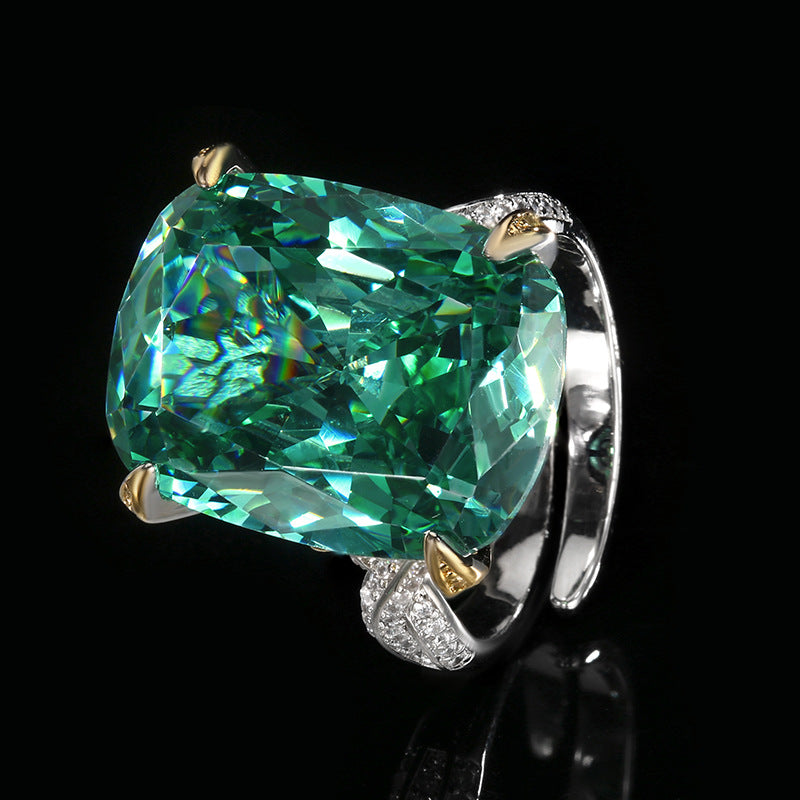 The ring of the emerald zirconia jewelry set,  inlaid with a large emerald-cut green center stone, pave band. Brass with silver-gold plating.