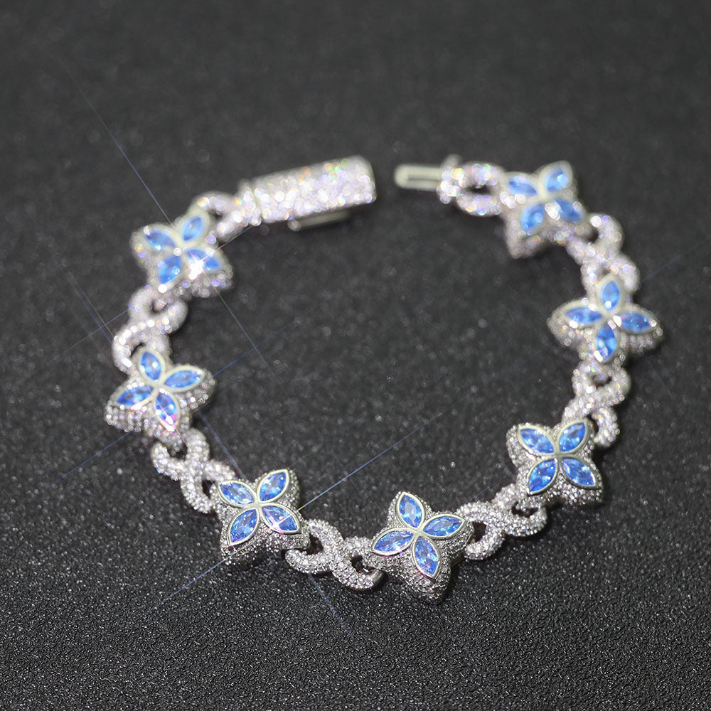 An iced out luxury big clover bracelet, infinity symbol, design in clovers with blue maquise stone. Iced out box clasp. Brass with silver plating.