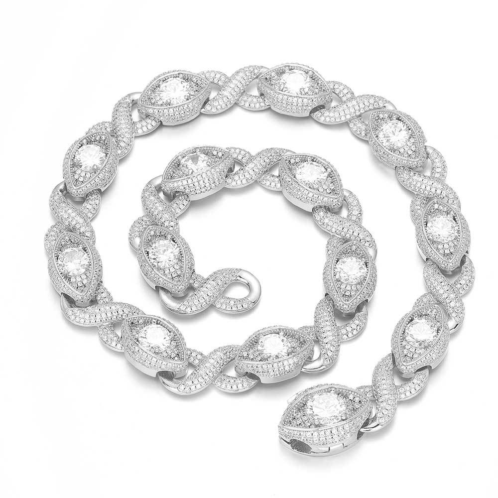 An iced out luxury evil eyes bracelet, infinity symbol, evil eye design in white zirconias. Iced out box clasp. Brass with silver plating.