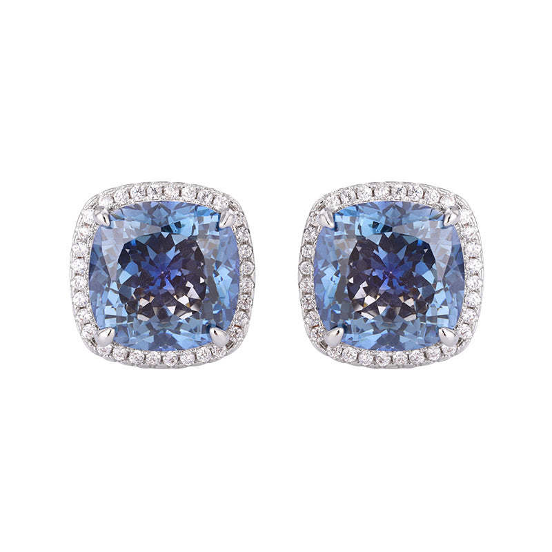 The stud earrings of the blue sapphire zirconia jewelry set, halo design with a blue center stone and white zirconias. Brass with silver plating.