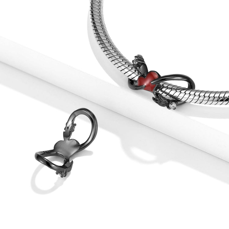 A sterling silver circular cupid's arrow design,with red enamel heart charm black