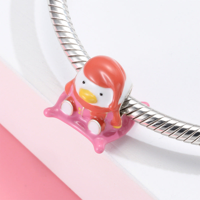 A sterling silver colorful enamel duck sitting on a mat charm